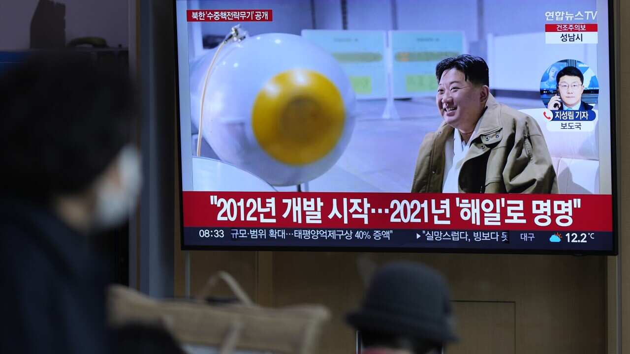 A TV screen shows an image of North Korean leader Kim Jong-un.