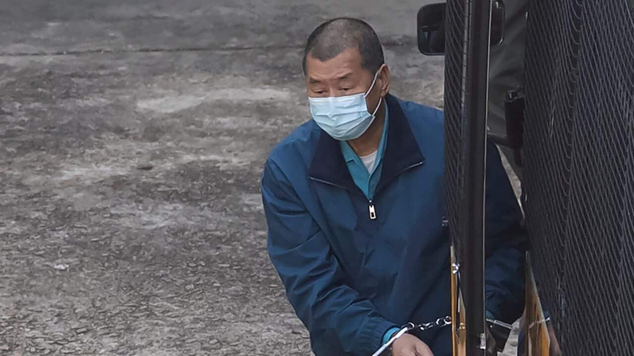 Jimmy Lai is escorted by Correctional Services officers to prison in Hong Kong, Thursday, Dec. 3, 2020.