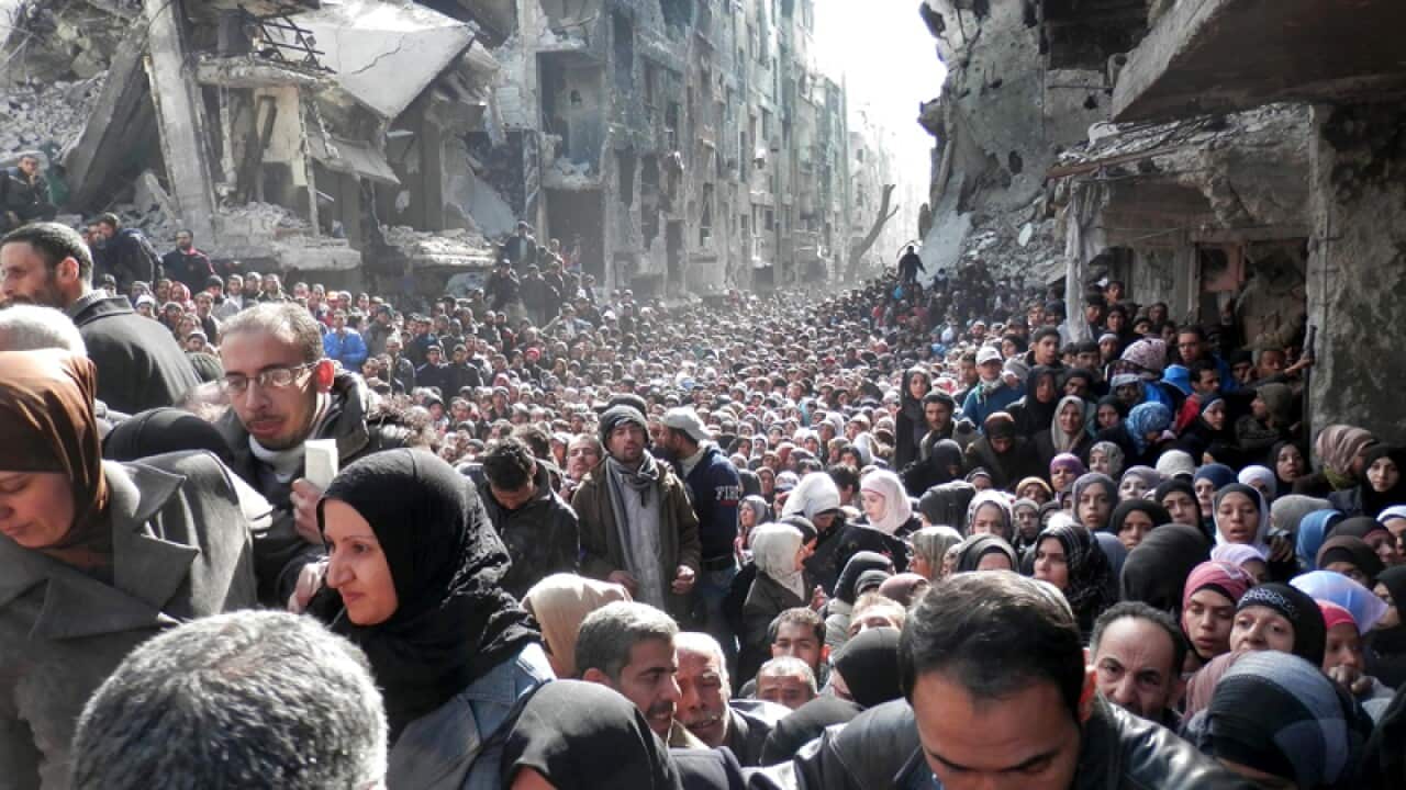 People line of for food supplies in Damascus.
