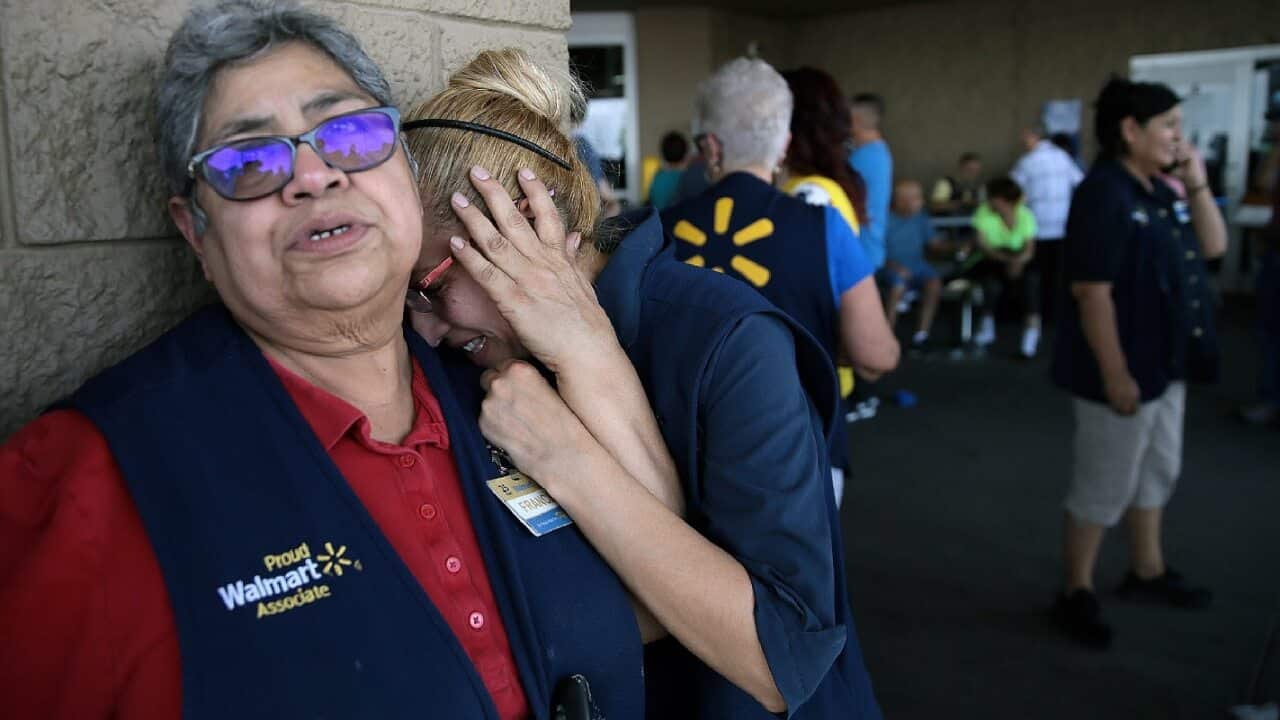 Walmart employees react after an active shooter opened fire at the store in El Paso, Texas, Saturday, Aug. 3, 2019.