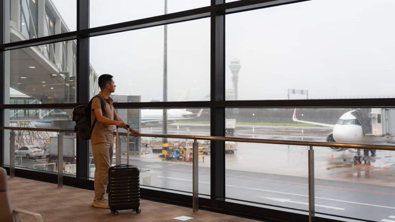 Passengers at the airport terminal window