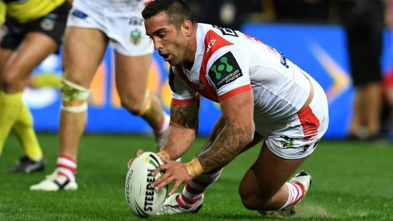 Paul Vaughan of the Dragons scores a try during round 24.