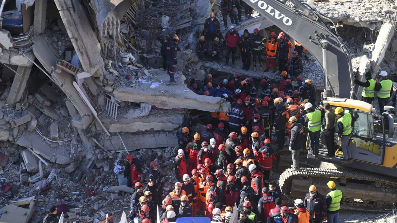 Rescue workers continue to look for people trapped under debris following a strong earthquake that destroyed several buildings on Friday.