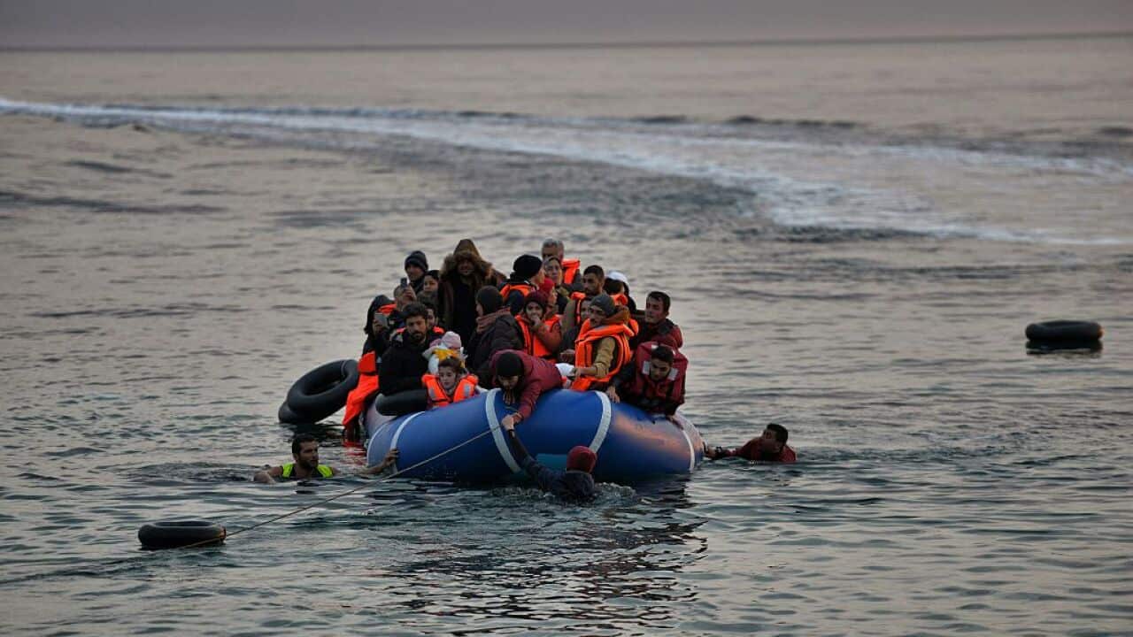 Refugees and migrants massed onto an inflatable boat