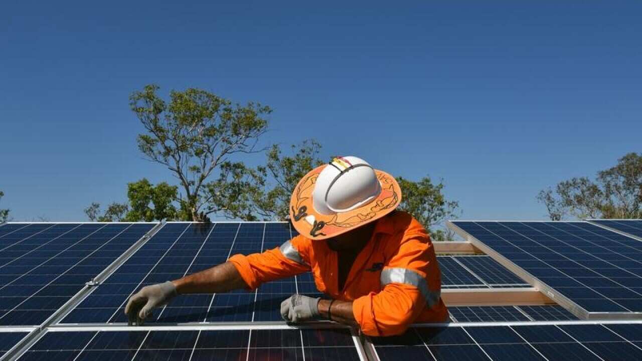 Northern Territory workers install solar panels