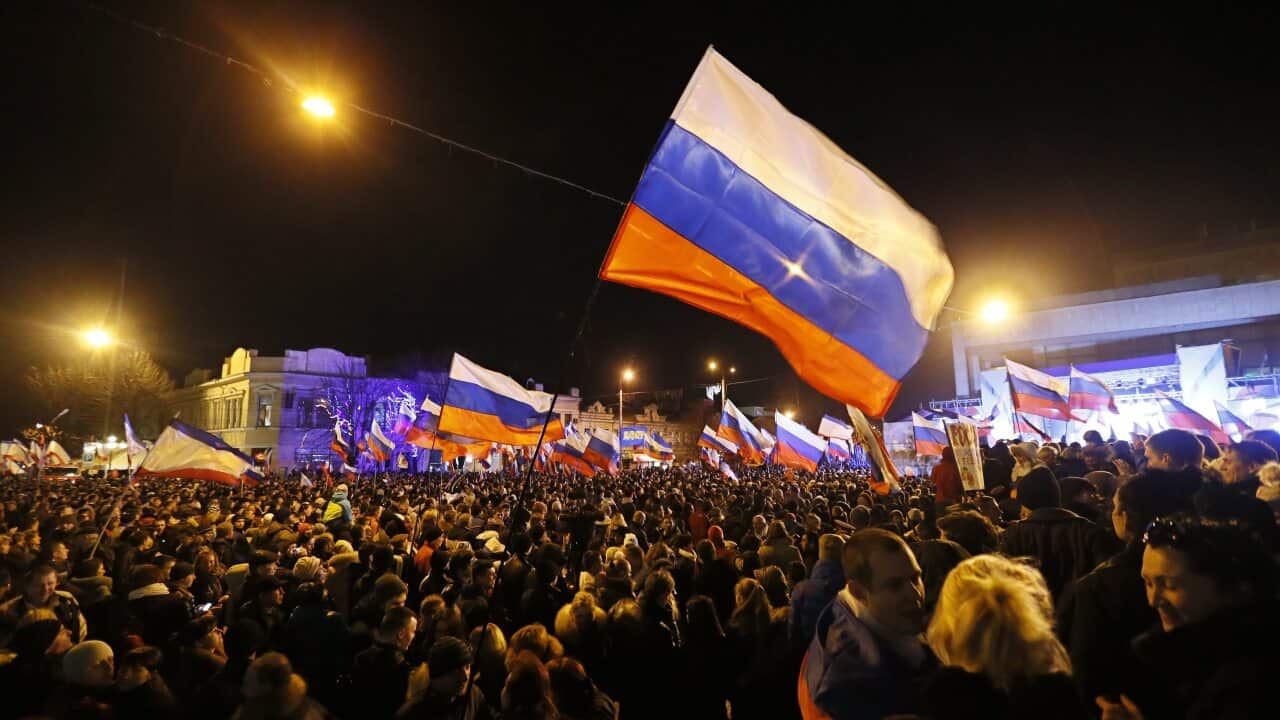 People hold Russian flags as they celebrate in Lenin Square after the end of the referendum in Simferopol - AAP-1.jpg