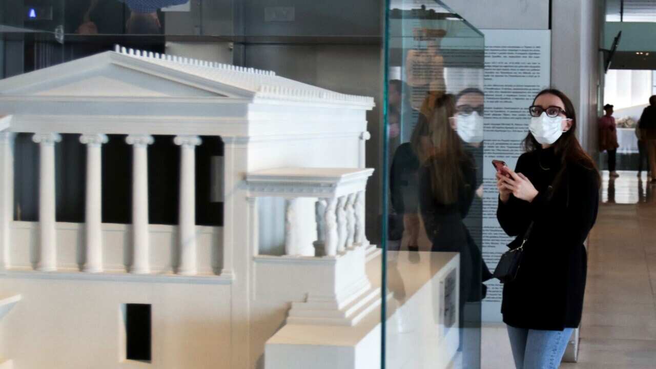 A tourist wearing a face mask in the Acropolis Museum