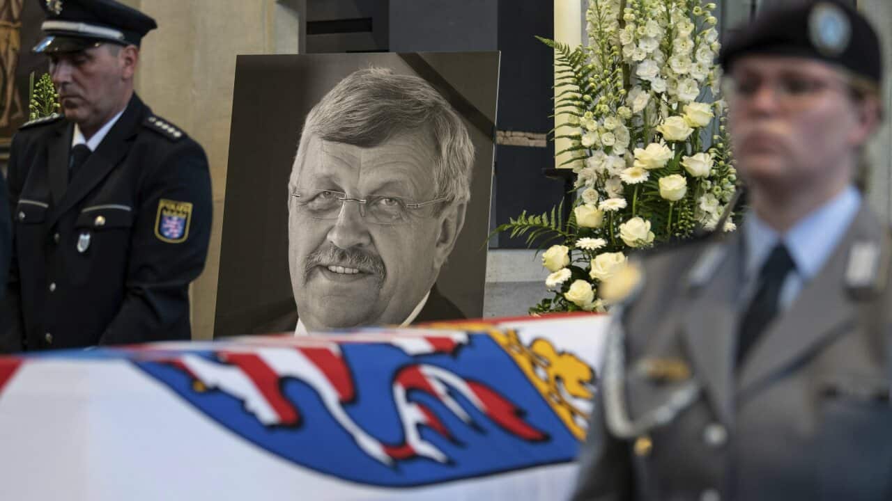 A picture of Walter Luebcke stands behind his coffin during the funeral service in Kassel, Germany.