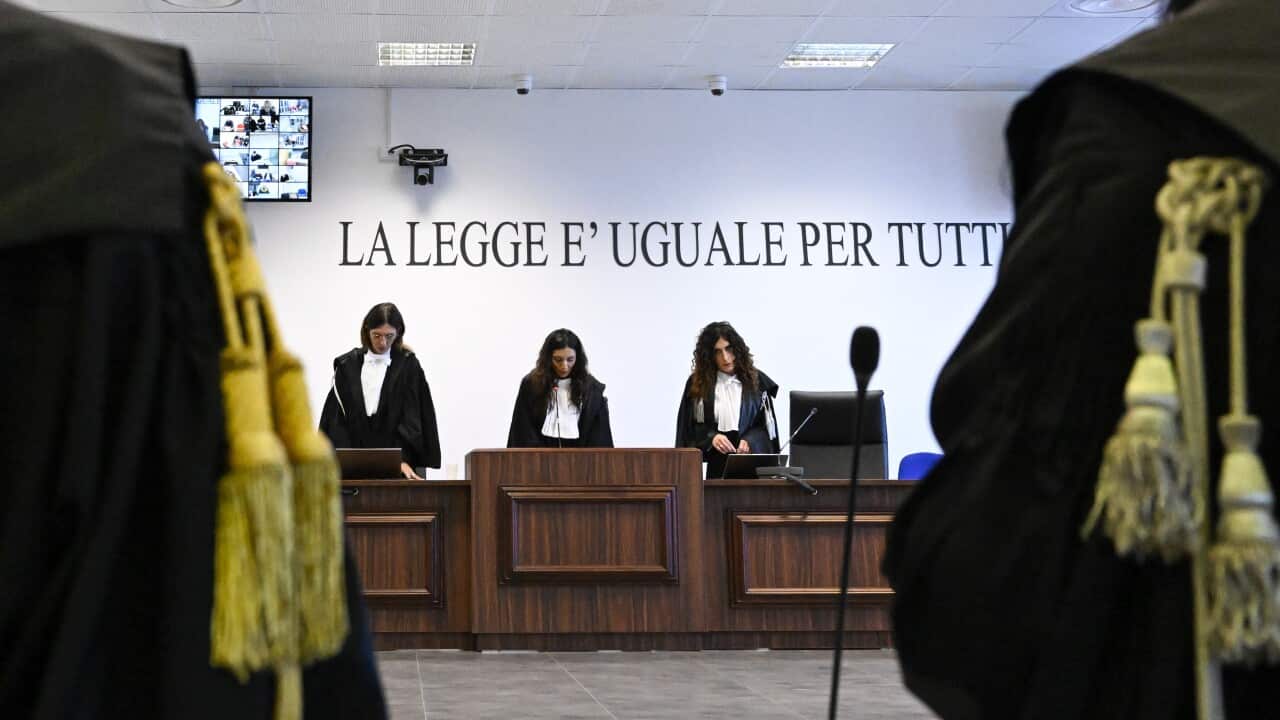 President of the court judge Brigida Cavasino, center, flanked by judges Claudia Caputo, left, and Germana Radice, reads the verdicts of a maxi-trial of hundreds of people accused of membership in Italy's 'ndrangheta organized crime syndicate, one of the world's most powerful, extensive and wealthy drug-trafficking groups, in Lamezia Terme, southern Italy, Monday, Nov. 20, 2023.