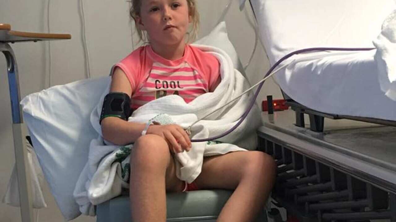 Gracie Mawn in a hospital room after being stung by a stonefish