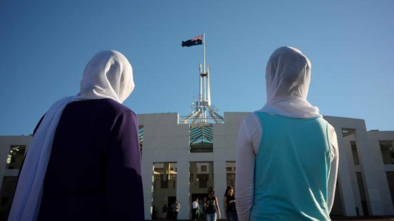 Visitors of Afghan nationality wearing hijabs at Parliament House in Canberra