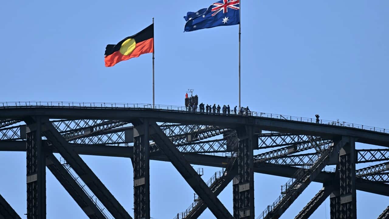 Australia's flag and the Aboriginal flag are seen atop the Sydney Harbour Bridge in Sydney.