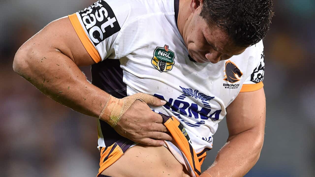 Broncos player James Roberts inspects an injury