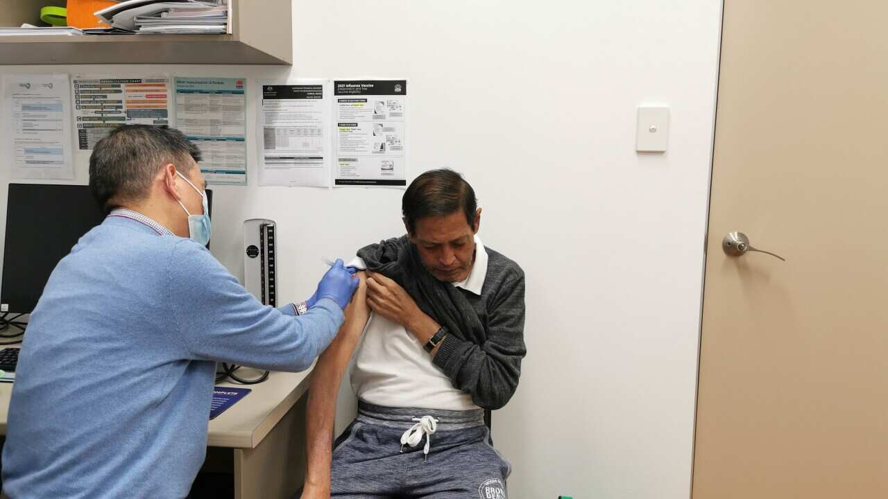 Dr. Zeng is giving vaccinations to those who have made appointments