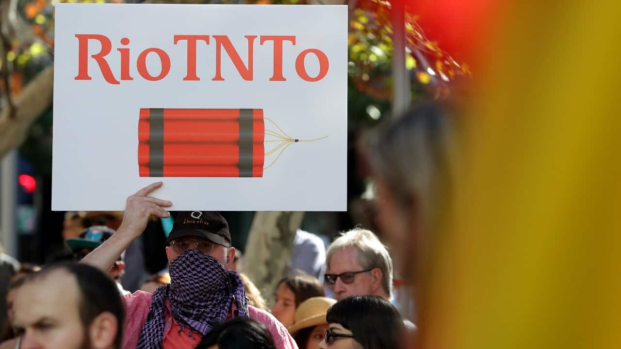 Protesters are seen during a rally outside the Rio Tinto office in Perth in June