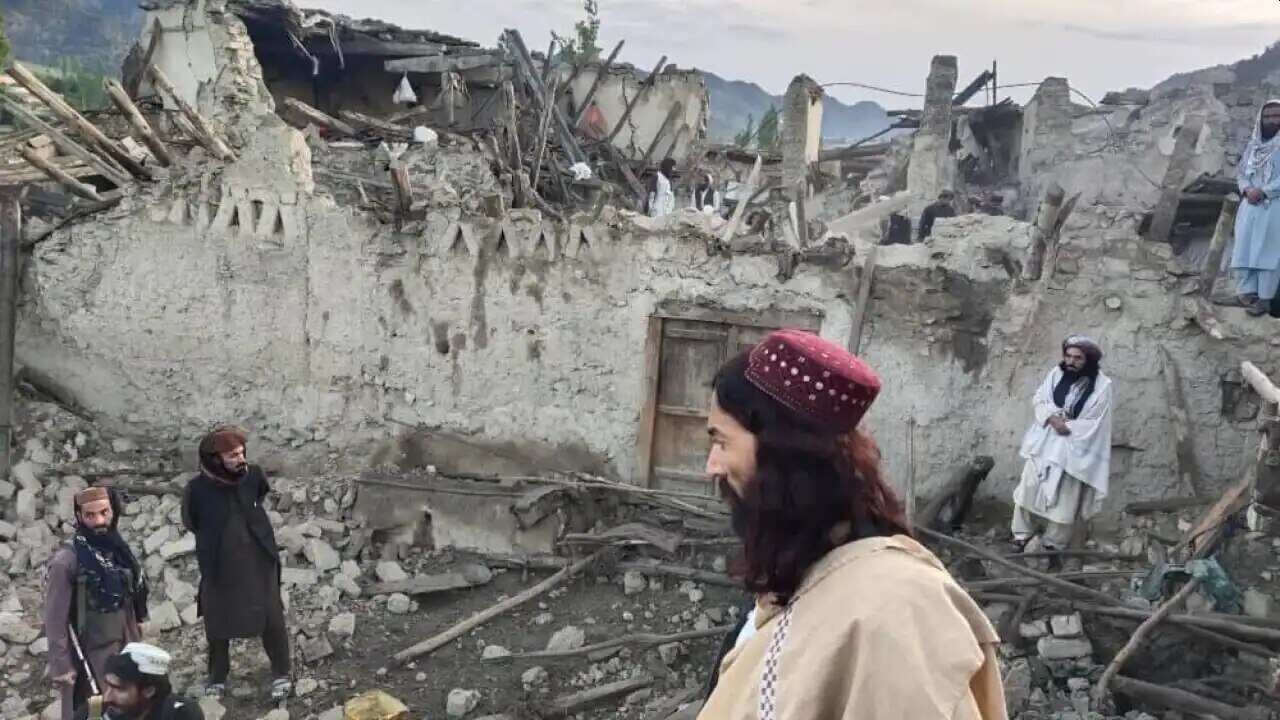 In this photo released by news agency Bakhtar, Afghans look at the destruction caused by an earthquake in the province of Paktika, eastern Afghanistan, on Wednesday, 22 June 2022.
