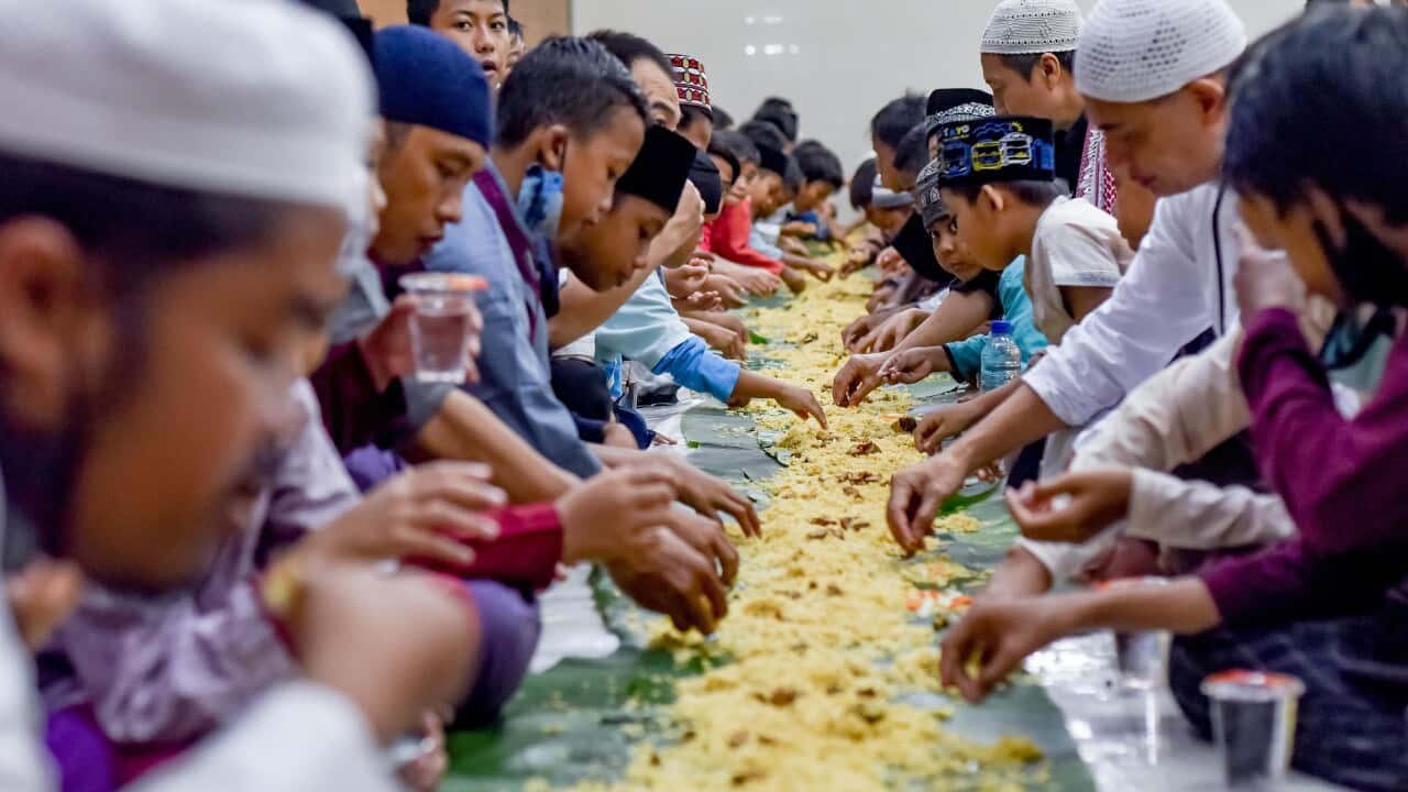 People have their iftar, the fast breaking meal, during the holy month of Ramadan at Baitul Makmur Mosque in Bali, Indonesia, April 8, 2022. (Photo by Bisinglasi/Xinhua via Getty Images).