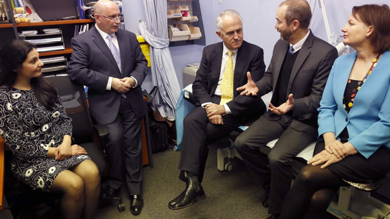 Malcolm Turnbull and Sussan Ley (R) listen to health professionals