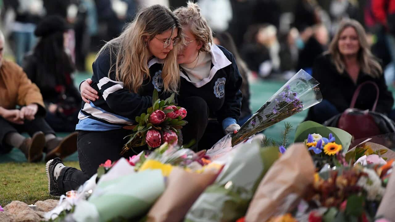 Attendees are seen at a memorial for Eurydice Dixon, at the Relcaim Princess Park Vigil in Melbourne, Monday, June 18, 2018.