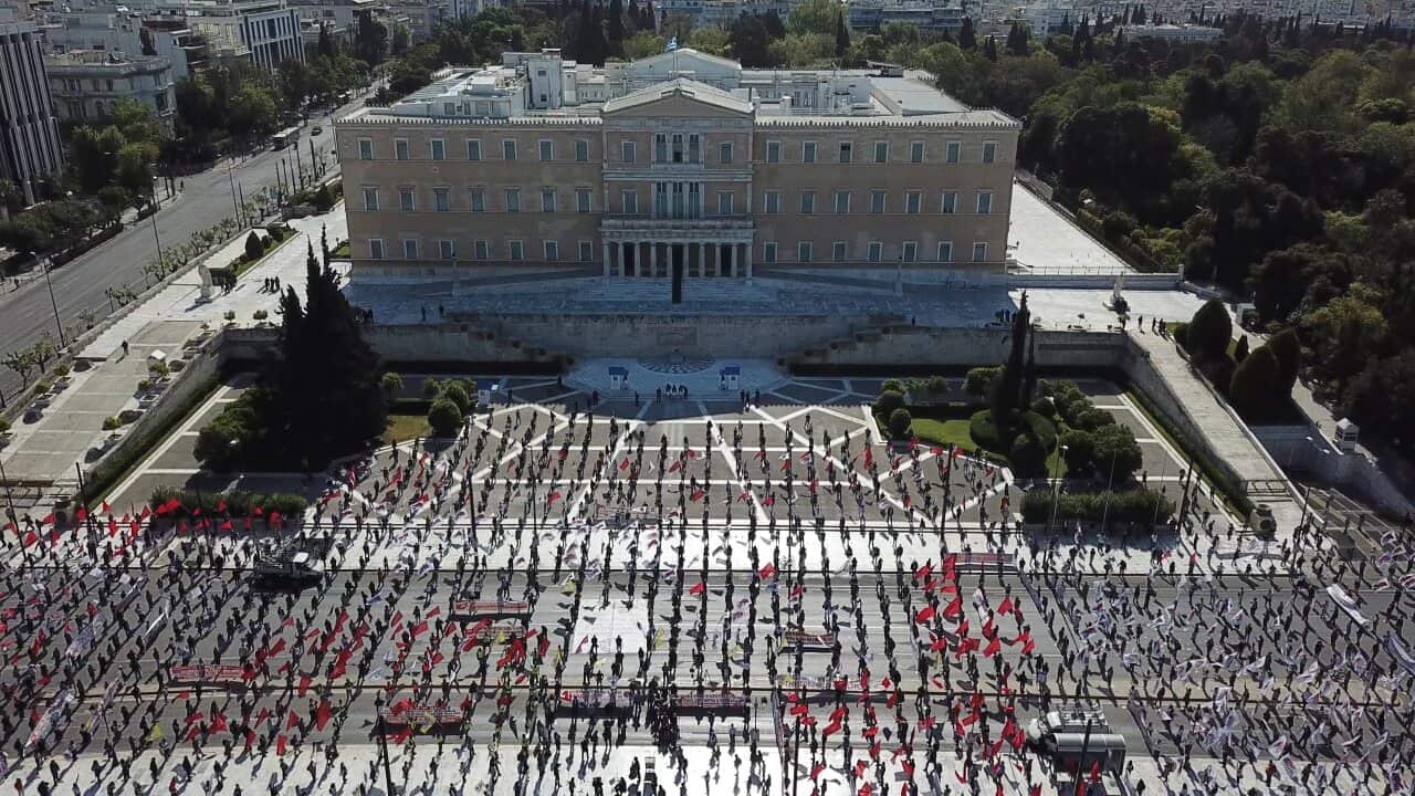 Protesters practice social distancing during a May Day rally outside the Greek Parliament, in Athens.