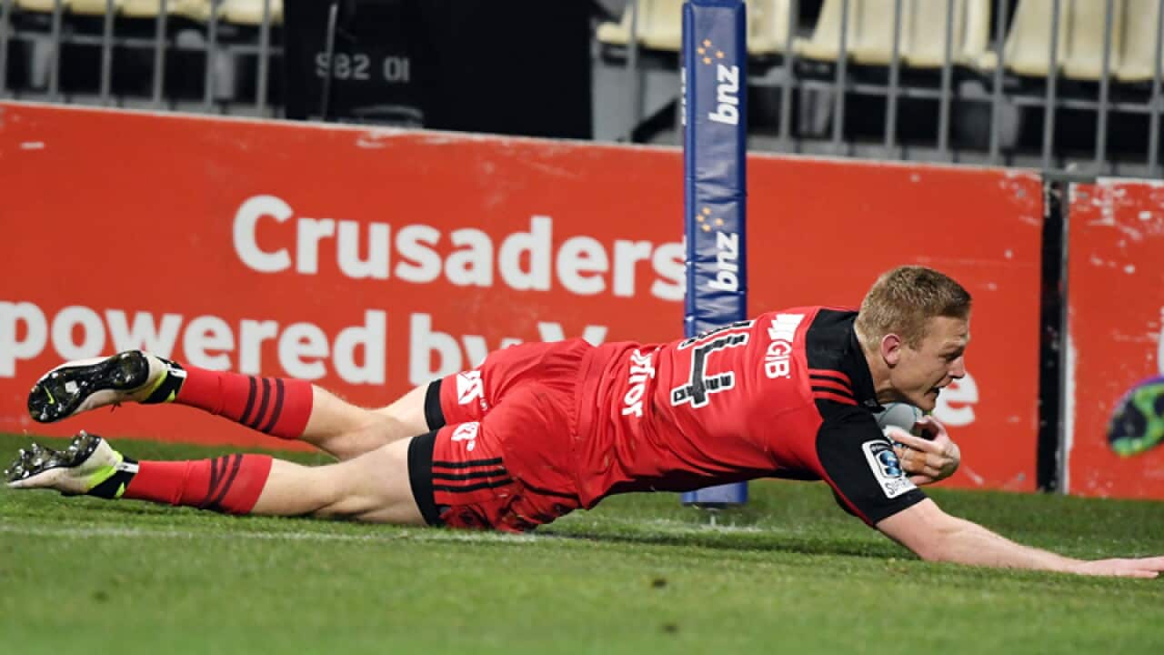 Johnny McNicholl of the Crusaders scores against the Rebels