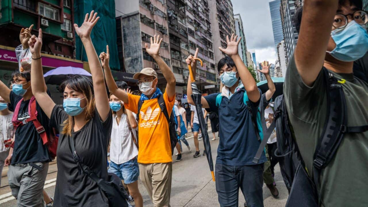 Protesters march in defiance of police ban despite security