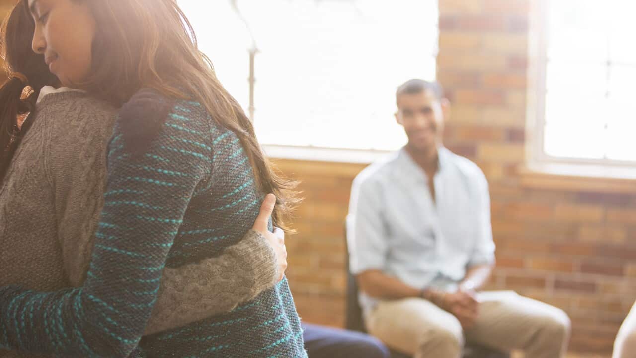 Women hugging at group therapy session