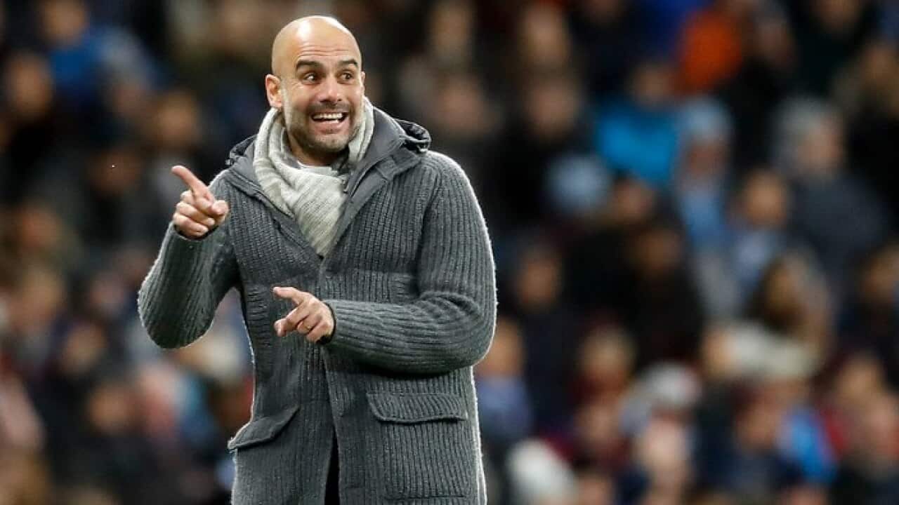 Manchester City manager Pep Guardiola on the touchline.