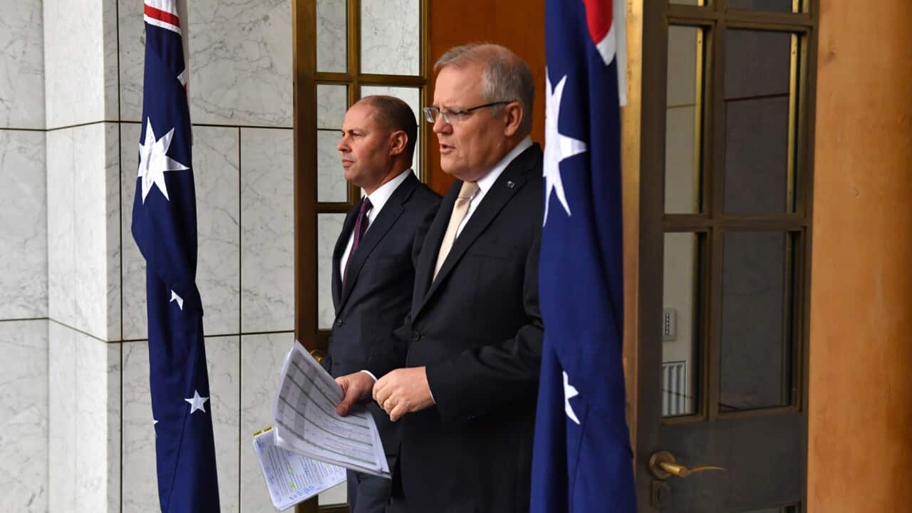 Treasurer Josh Frydenberg and Prime Minister Scott Morrison arrive to speak to the media during a press conference at Parliament House in Canberra, Thursday, March 12, 2020. (AAP Image/Mick Tsikas) NO ARCHIVING