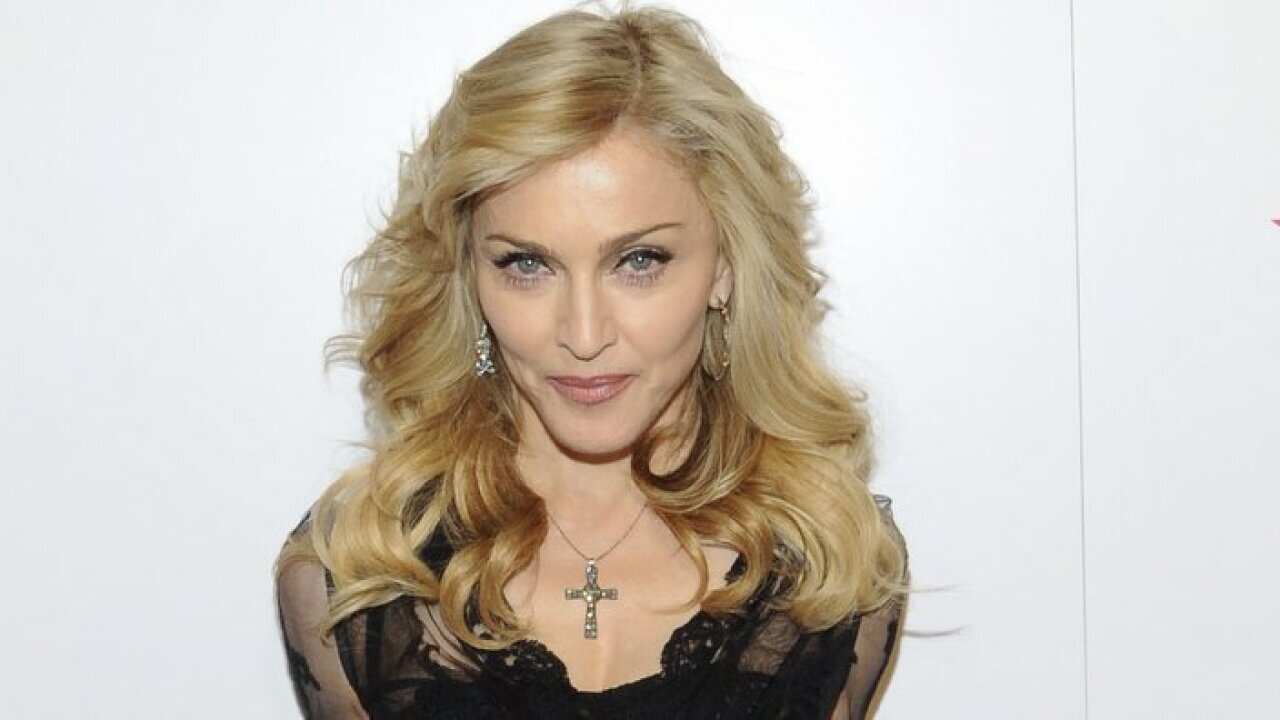 Singer Madonna arrives at Macy's Herald Square to launch her new fragrance "Truth or Dare By Madonna" on Thursday, April 12, 2012 in New York. (AP Photo/Evan Agostini)