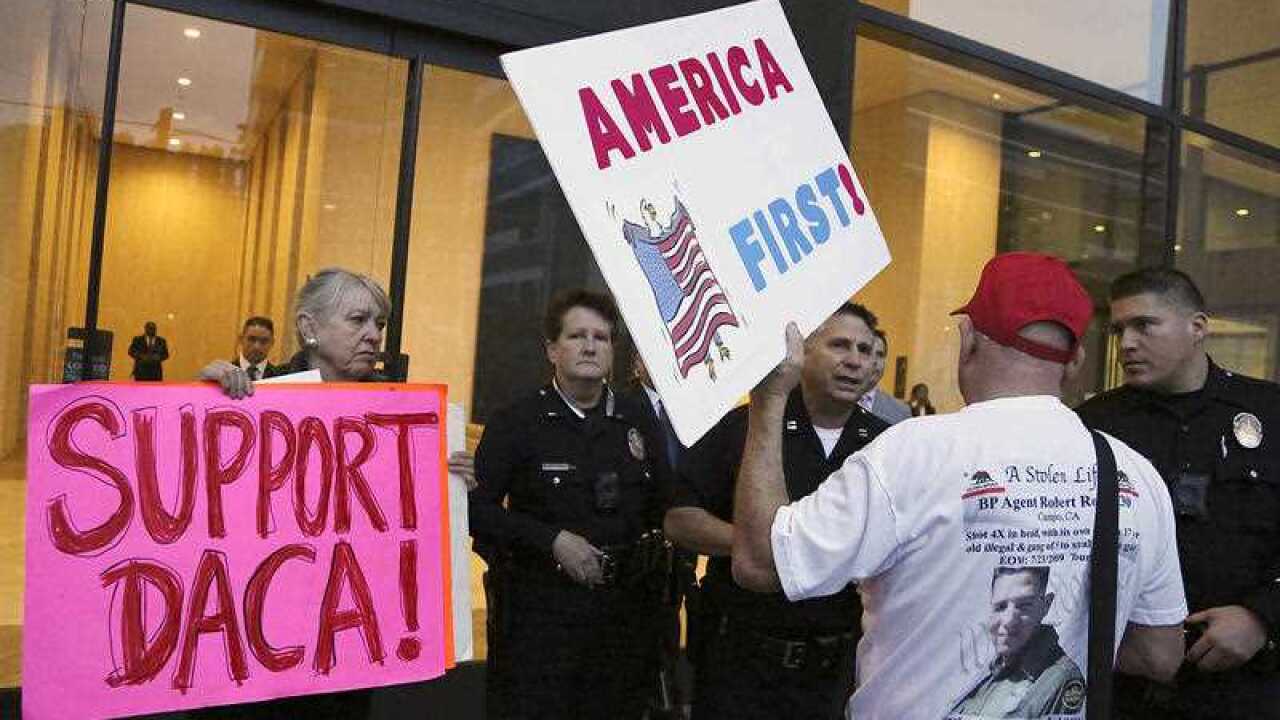 In this file image, a supporter of President Donald Trump challenges police officers and a Deferred Action for Childhood Arrivals (DACA) program during a rally outside the office of California Democratic Sen. Dianne Feinstein in Los Angeles