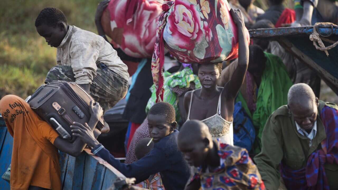 Displaced people get off a river barge