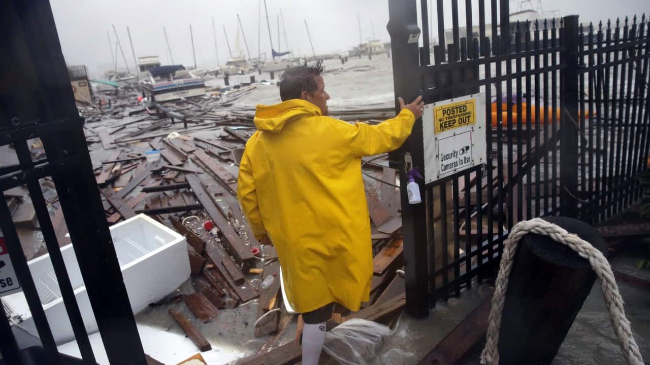 Jame Rowles examines the damage after the docks at the marina where his boat was secured were destroyed as Hurricane Hanna made landfall in Texas.