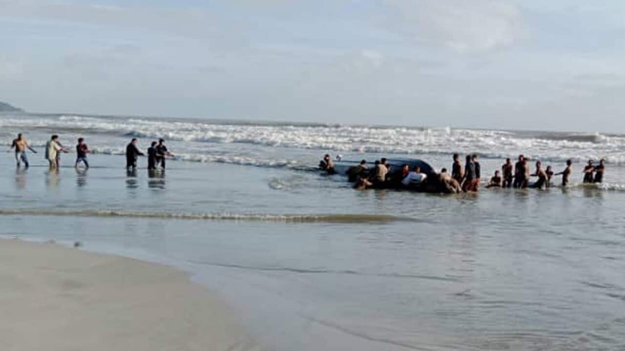 Malaysian authorities recovering a capsized boat on the Tanjung Balau Beach in Kota Tinggi, Johor State, Malaysia, 15 December 2021