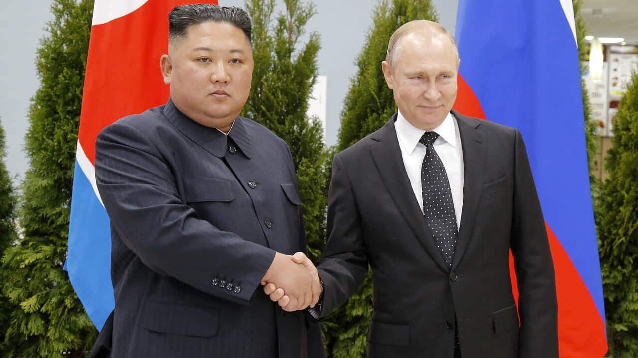 Russian President Vladimir Putin and North Korea's leader Kim Jong-un shake hands.