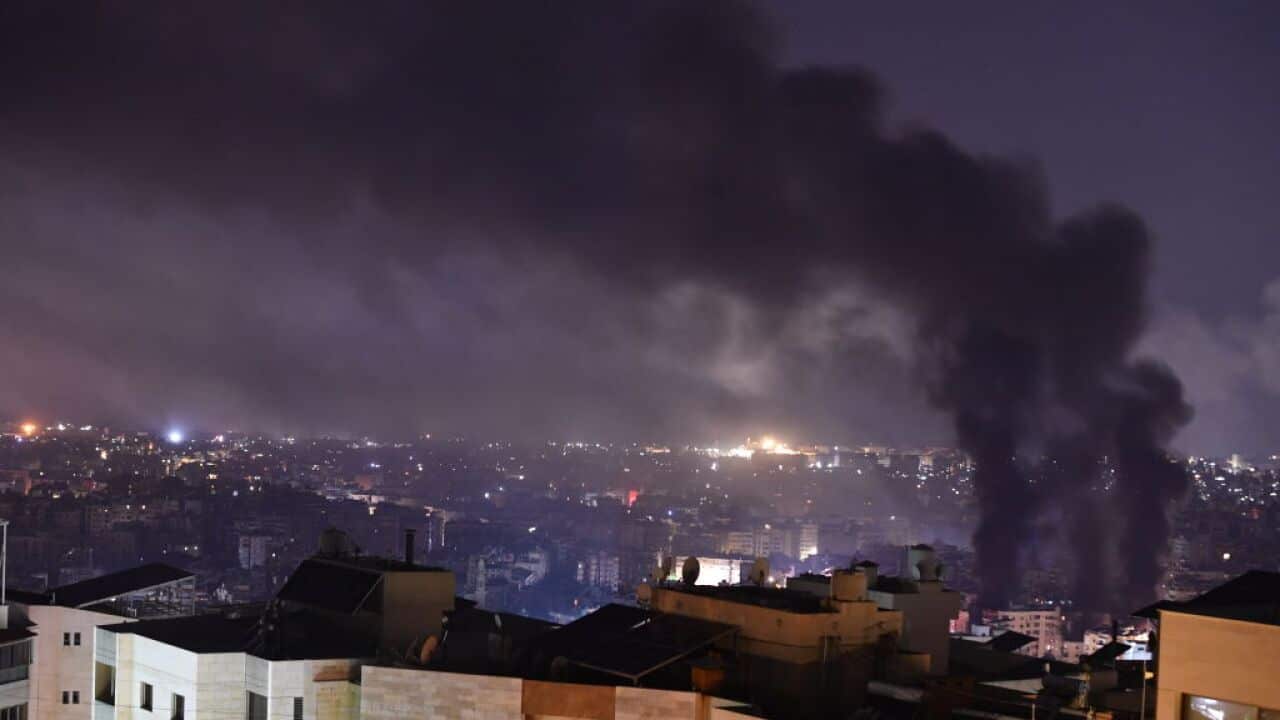 Plumes of smoke rise from the site of an airstrike.