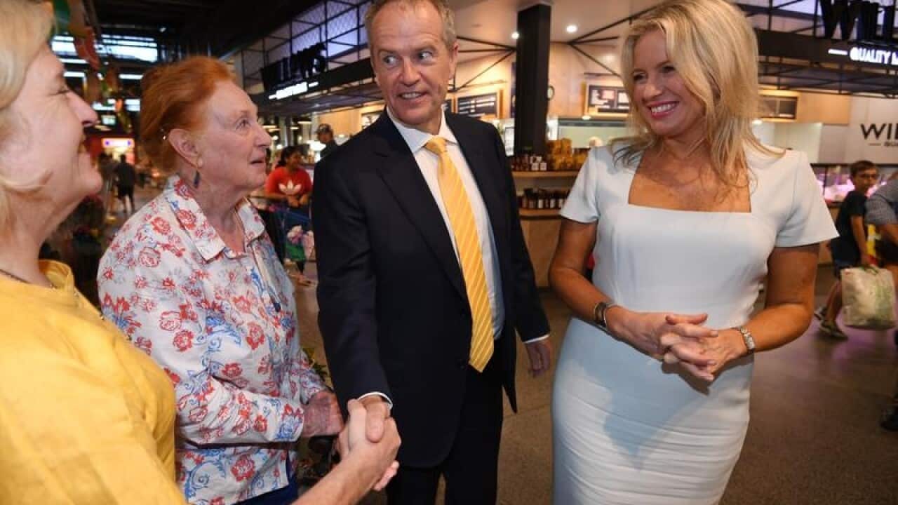 Bill Shorten and wife Chloe (right) greet shoppers in Brisbane.