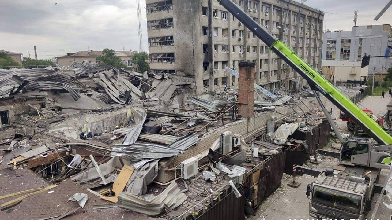 Rescuers at work at the site of a rocket strike in downtown Kramatorsk