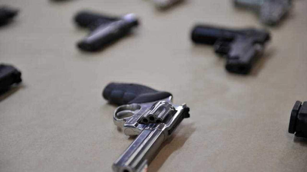 A selection of hand guns are displayed at the Police Centre in Sydney on Wednesday, Aug. 8, 2012. (AAP Image/Paul Miller)
