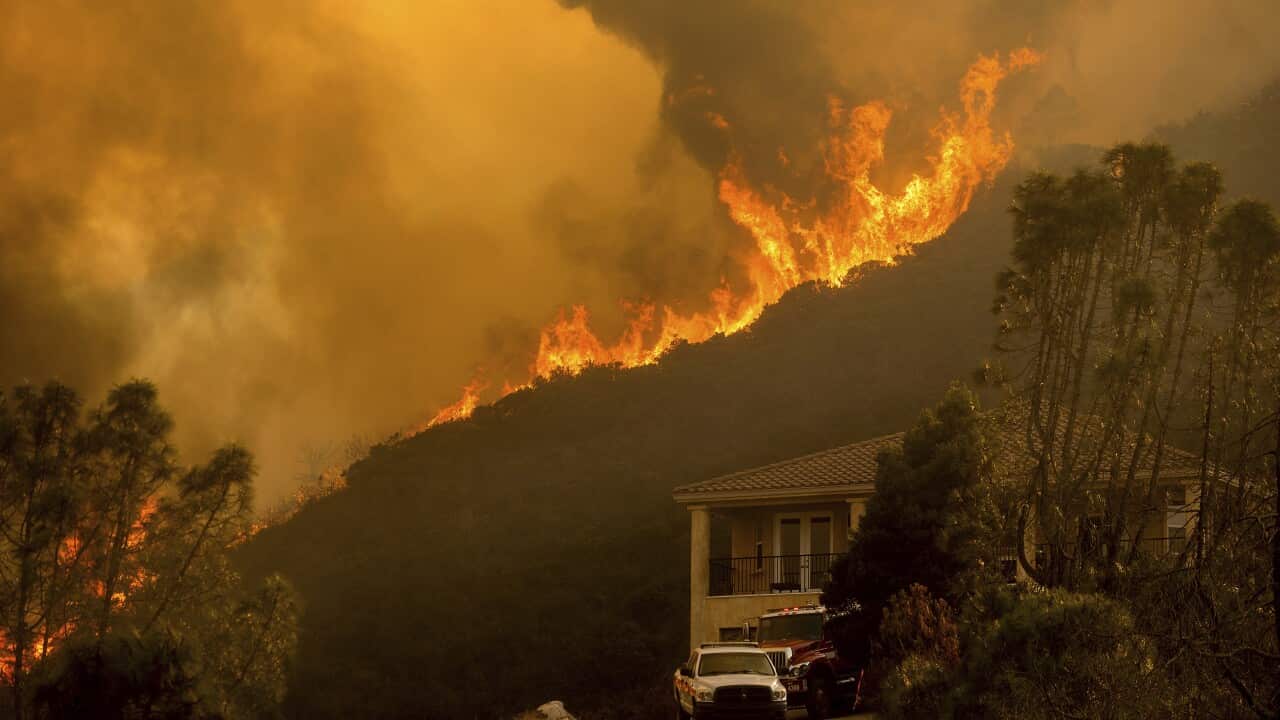 Flames from the River Fire crest a ridge in Salinas, California, on Monday.