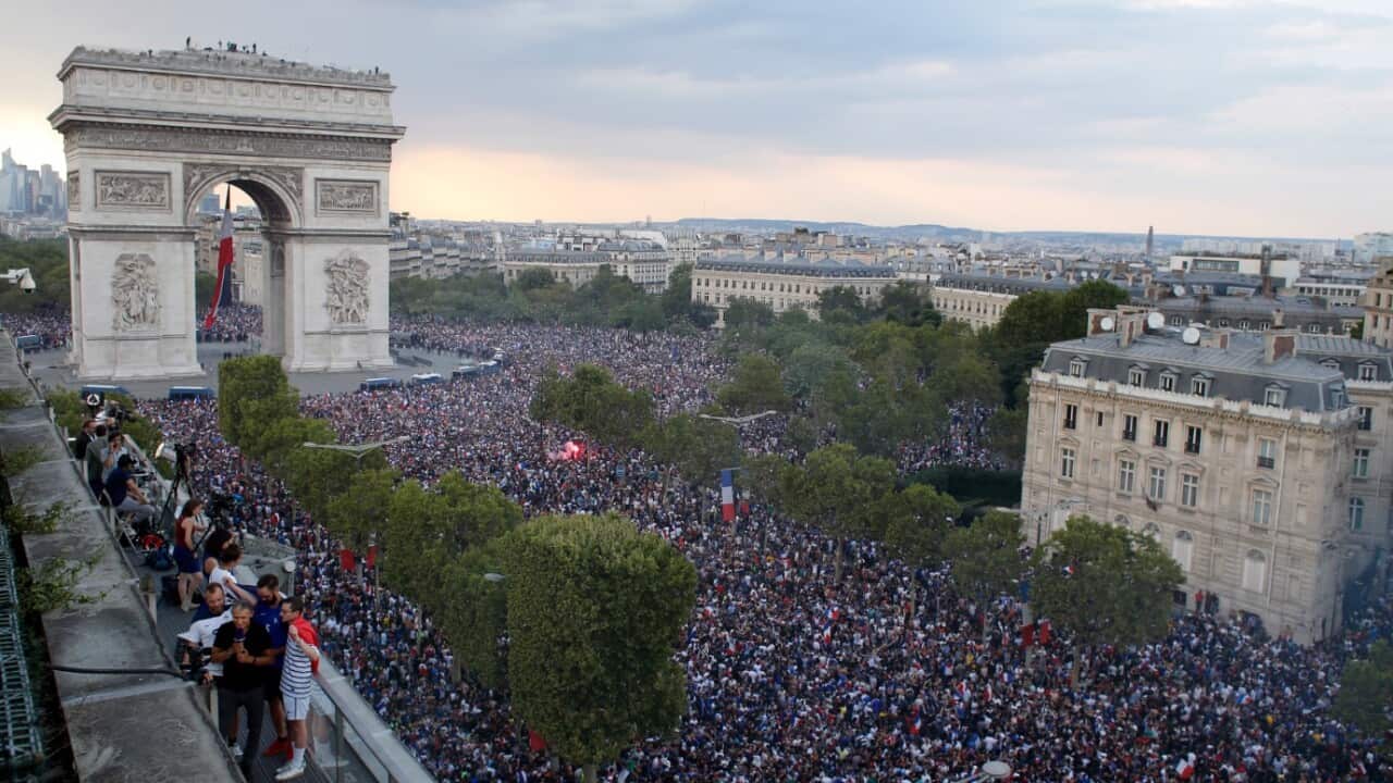 In this picture taken from the terrace of the Publicis Group people take the streets around the Arc de Triomphe to celebrate France's World Cup victory