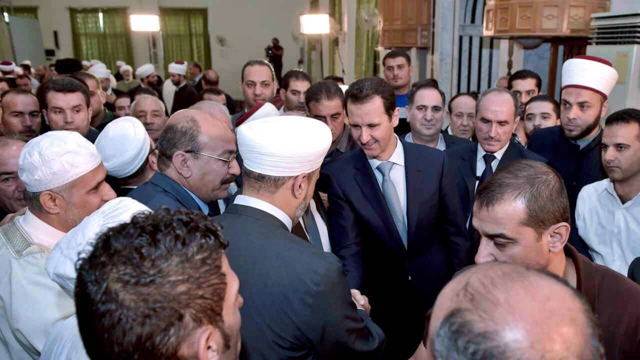 Syrian President, Bashar al-Assad (canter - R), greeting prominent religious figures following Eid al-Adha prayers in a rare public appearance at the al-Adel Mosque in Damascus, Syria