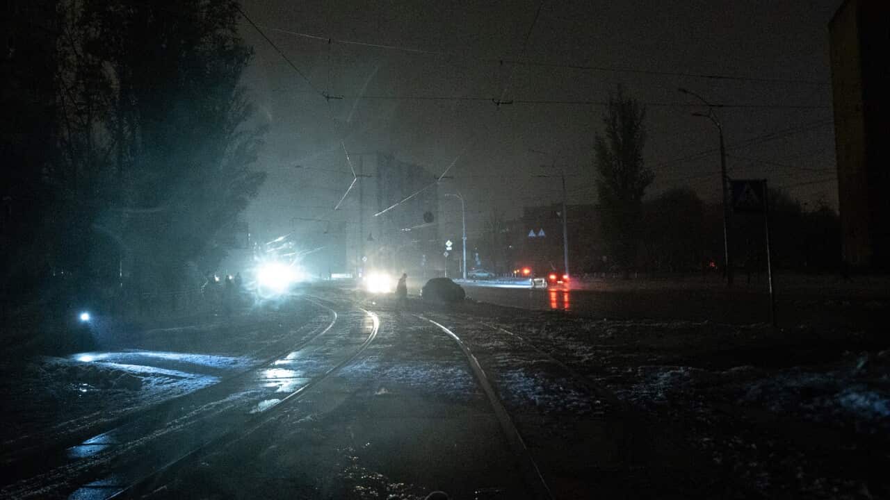 Car headlights are the only illumination in blacked-out Kyiv