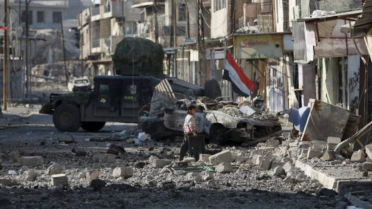 A boy walks among the debris of a damaged neighbourhood as Iraqi security forces advance during fighting against Islamic State militants in western Mosul.