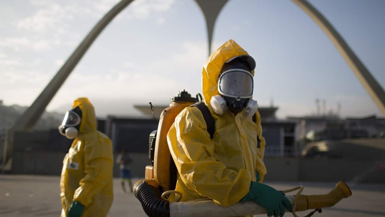 Health workers spray insecticide in Rio de Janeiro.