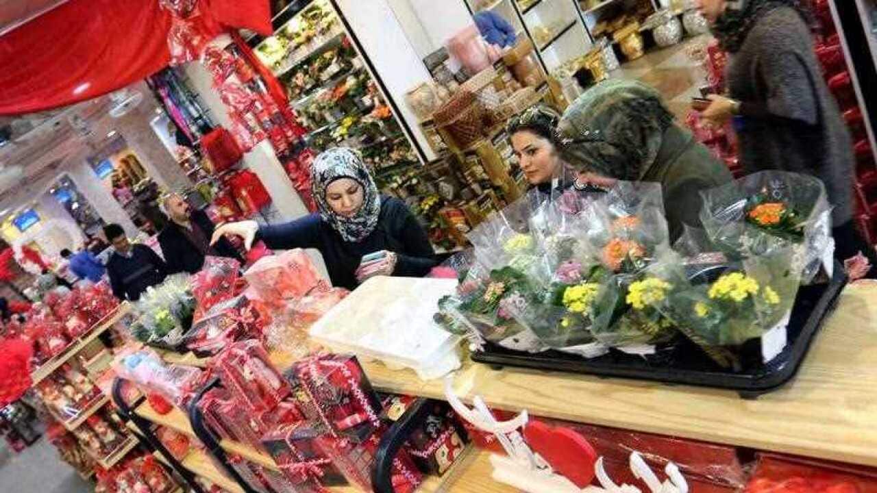 Iraqis look at gifts displayed for sale at a shope during Valentine's day, in Baghdad, Iraq.
