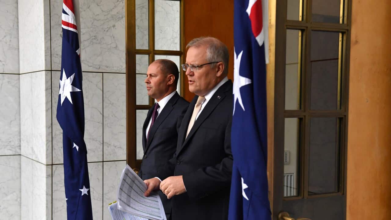 Treasurer Josh Frydenberg and Prime Minister Scott Morrison arrive to speak to the media during a press conference at Parliament House in Canberra, Thursday, March 12, 2020. (AAP Image/Mick Tsikas) NO ARCHIVING