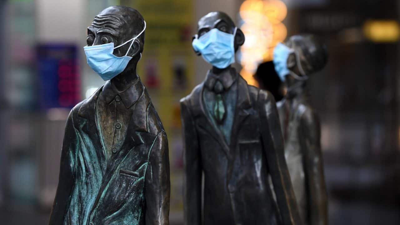 Masks are seen on a statue along Swanston street in Melbourne, Monday, July 20, 2020.