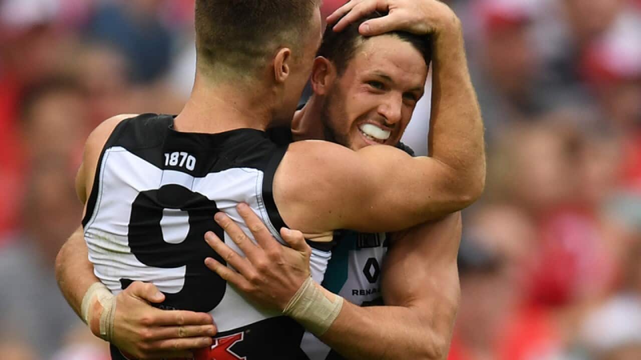 Travis Boak of the Power celebrates his goal with Robbie Gray