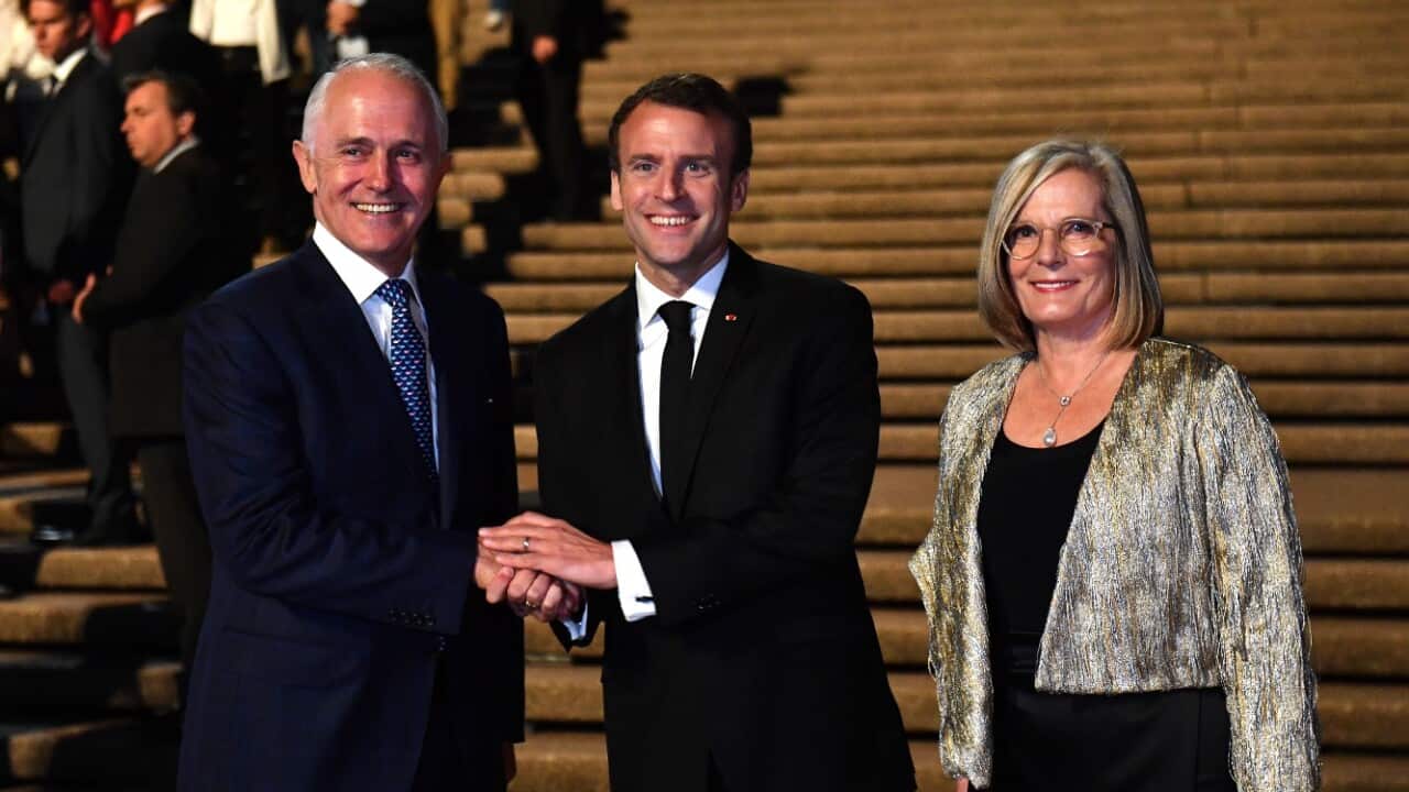 President of France Emmanuel Macron (centre) meets with Australia's Prime Minister Malcolm Turnbull and his wife Lucy Turnbull